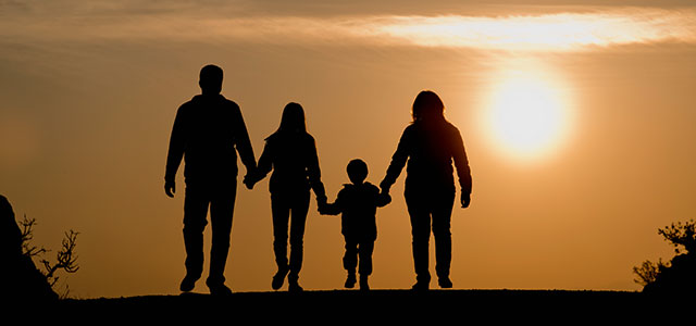 A family walking together during sunset Photo of a family holding hands and walking and receiving family law services from The Offices of Lawrence j. Signore in Providence, RI