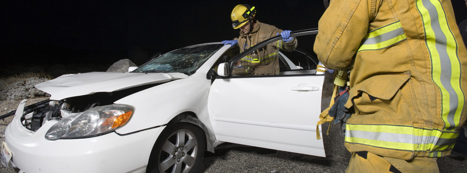 A wrecked car which was involved in a transporation accident Photo of firefighters surrounding a crashed car, the driver of which will hire The Law Offices of Lawrence J. Signore in Providence, RI